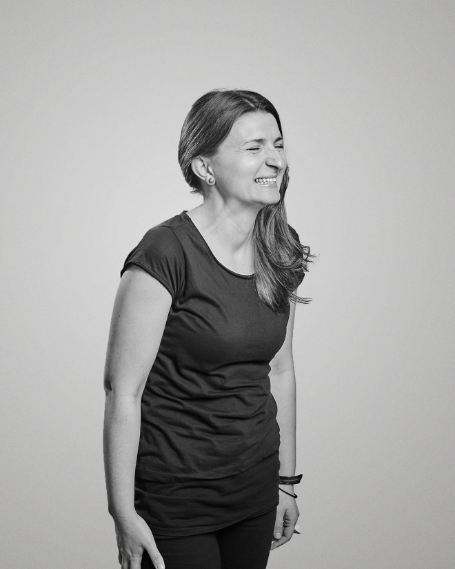 Black and white photo of kreesha with wild smile.